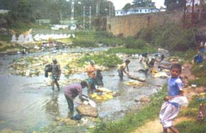 Another view of people washing clothes in Umshyrpi stream despite of its being already highly polluted